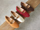 Group shot of Crane mary jane shoes in caramel suede, gold leather, port suede, coffee suede.