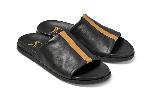 Crest leather slide sandals in black with tan stripe - product angle shot