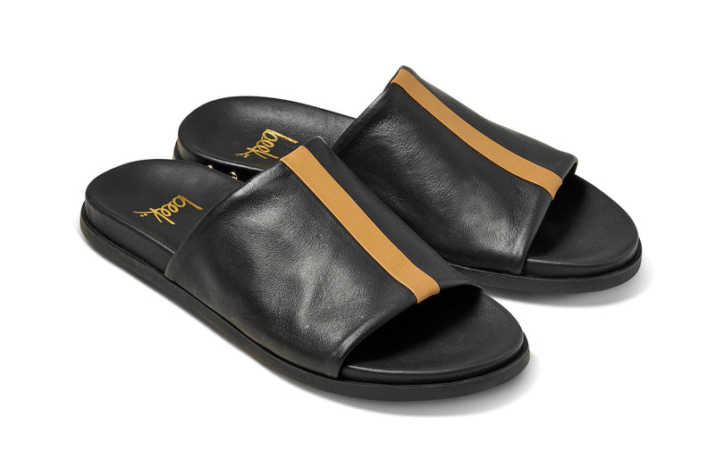 Crest leather slide sandals in black with tan stripe - product angle shot
