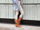 Woman wearing Crow tall leather boots in tan with beige pants and denim jacket