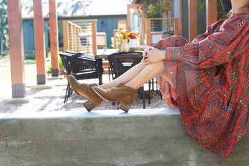 Woman wearing Eaglet suede boot in chestnut and dress.