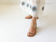 Woman wearing Emerald block heel sandal in honey with embroidered white dress