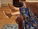 Woman wearing Falcon suede ankle booties in chestnut with floral dress