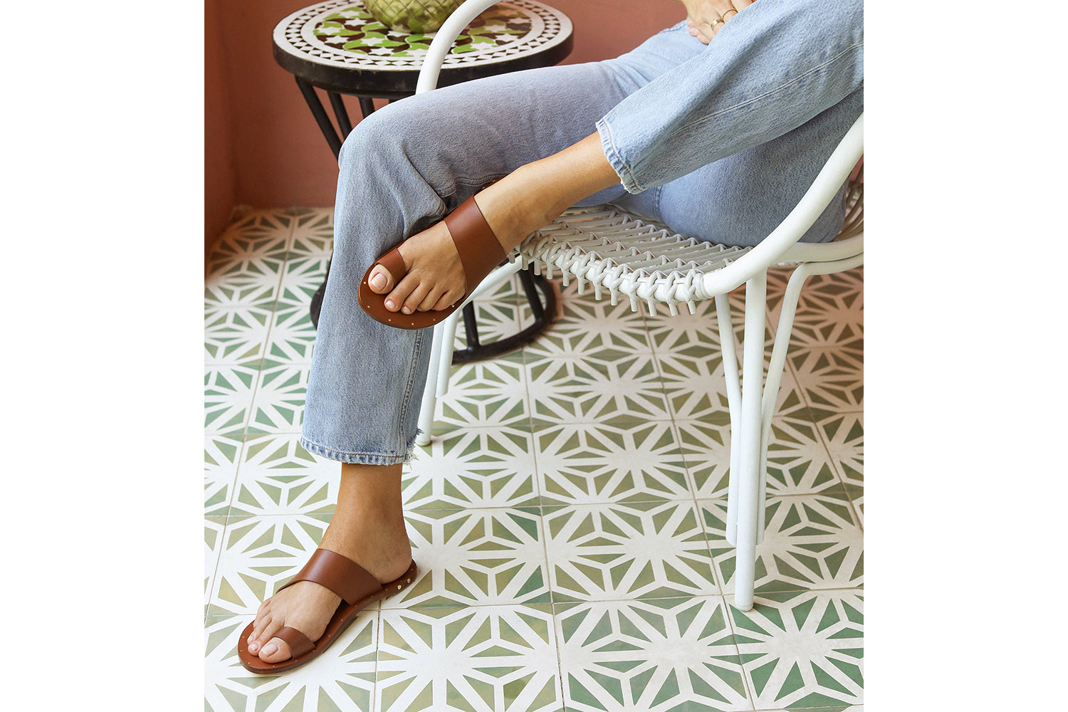 Woman wearing Finch leather toe-ring sandals in tan with jeans