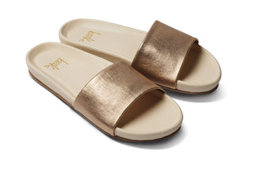 Gallito leather slide sandal in gold/eggshell - angle shot