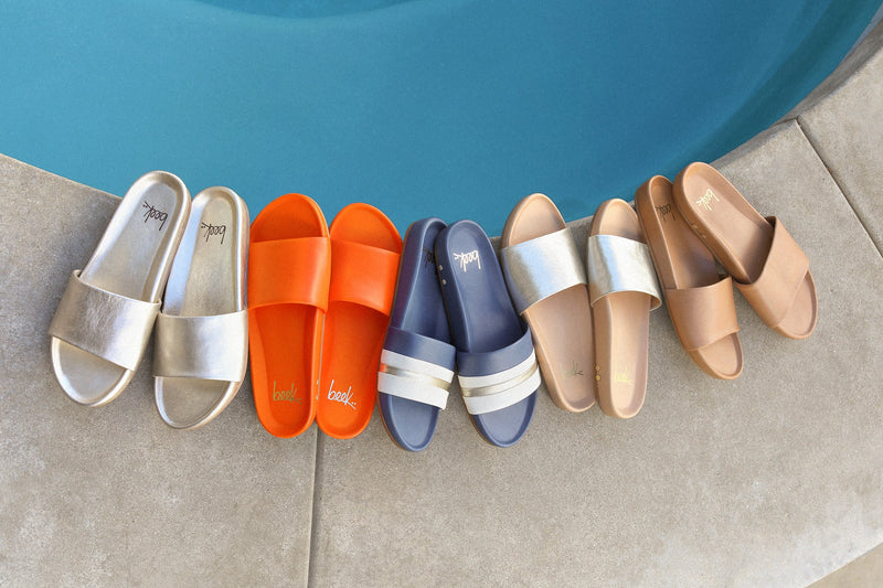 Group shot of Gallito leather slide sandals in platinum, flame, navy stripe, platinum/beach, and honey