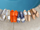 Group shot of Gallito leather slide sandals in platinum, flame, navy stripe, platinum/beach, and honey