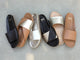 Group shot of Gallito leather slide sandals in black, platinum, platinum/beach, honey with Paloma leather slide sandals in gold/honey and bronze/black.