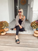 @ashnfashn wearing Gallito Shearling leather slide sandals in black with black pants, black tank, and beige cardigan.