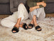 Women wearing Gallito Más Shearling slide sandals in army/black and Gallito Shearling in black.
