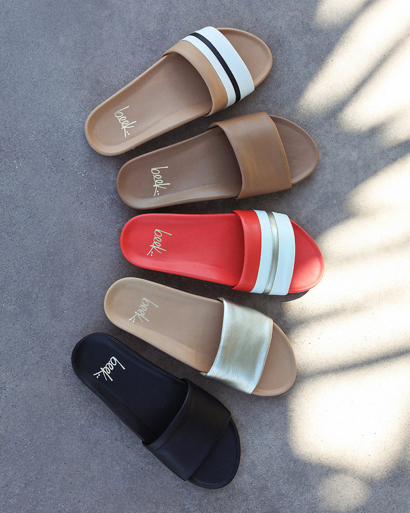 Group shot of Gallito Stripe leather slide sandals in tomato and beach with Gallito slide sandals in honey, platinum/beach, and black