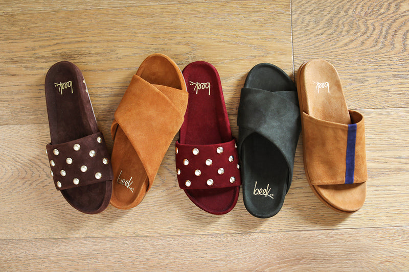 Group shot of Gallito Stud suede sandals in coffee and port with Kea suede crossover strap sandals in caramel and ivy with Crest suede sandals in caramel with navy stripe.