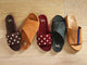 Group shot of Gallito Stud suede sandals in coffee and port with Kea suede crossover strap sandals in caramel and ivy with Crest suede sandals in caramel with navy stripe.