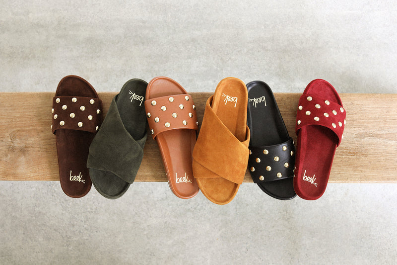 Group shot of Gallito Stud suede sandal in coffee, Kea suede slide sandal in ivy, Gallito Stud leather slide sandal in tan, Kea suede sandal in caramel, Gallito Stud leather slide sandal in black, and Gallito Stud suede slide sandal in port.