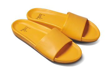 Gallito leather slide sandal in sunflower - angle shot