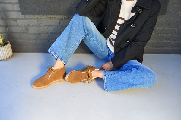 Woman wearing Goose suede shearling boot in chestnut with jeans and sweater and jacket