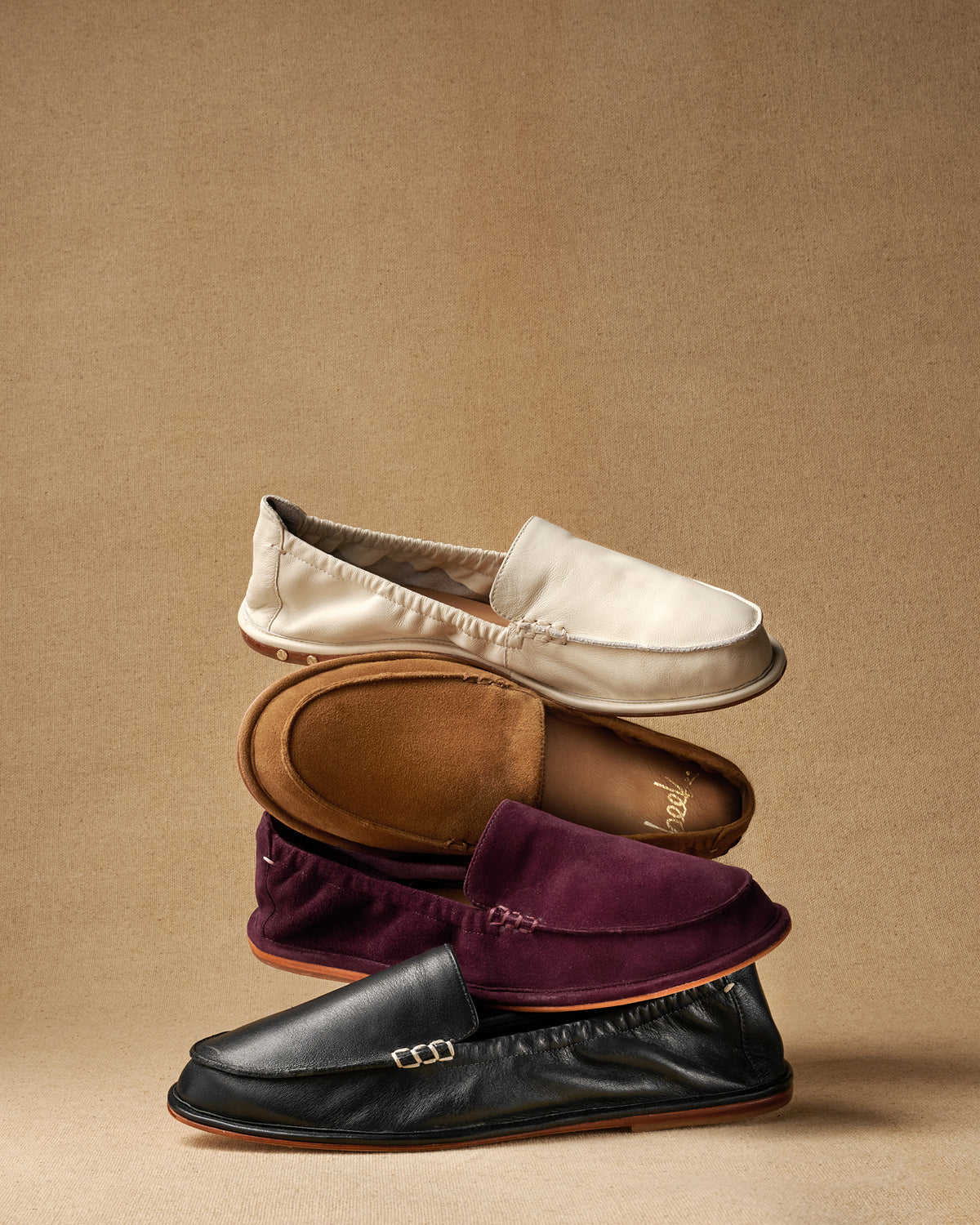 Group shot of Griffin loafers in eggshell leather, toffee suede, prune suede, black leather