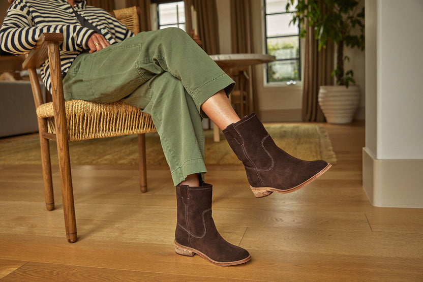 Woman wearing Grouse slouchy suede boot in coffee with olive pants and striped top