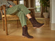 Woman wearing Grouse slouchy suede boot in coffee with olive pants and striped top