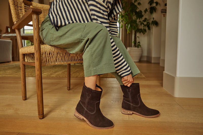 Woman wearing Grouse slouchy suede boot in coffee with olive pants and striped top