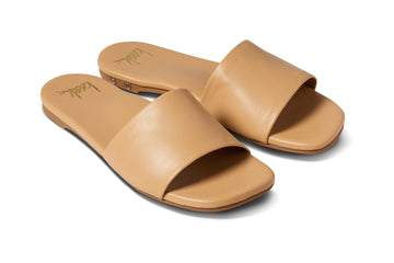 Honeybird leather slide sandals in beach - angle shot