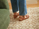 Woman wearing Huet leather buckle sandals in cognac with jeans
