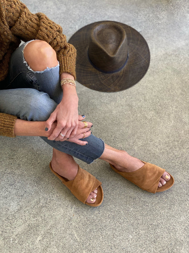 Woman wearing KEA suede slide sandal in caramel