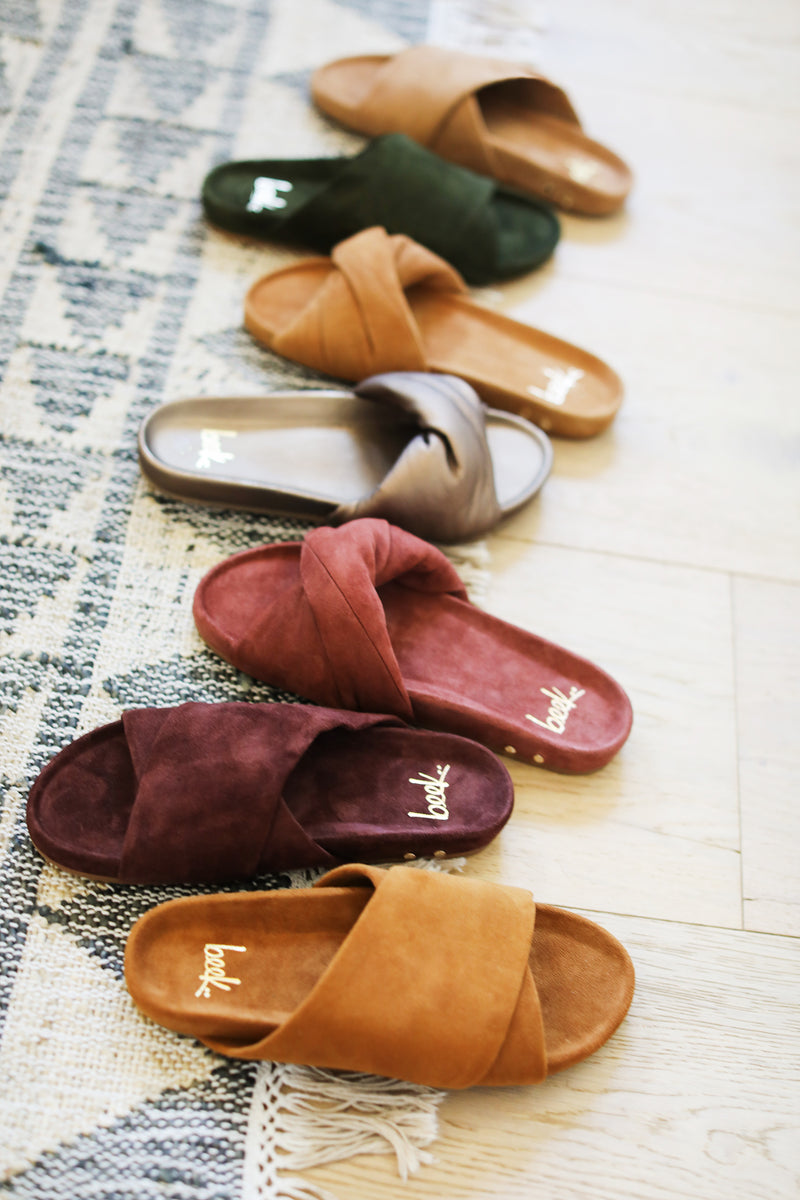 Group shot of Kea suede sandals in caramel, plum, moss almond with Tesia twisty sandals in fig suede, mocha leather, and almond suede.