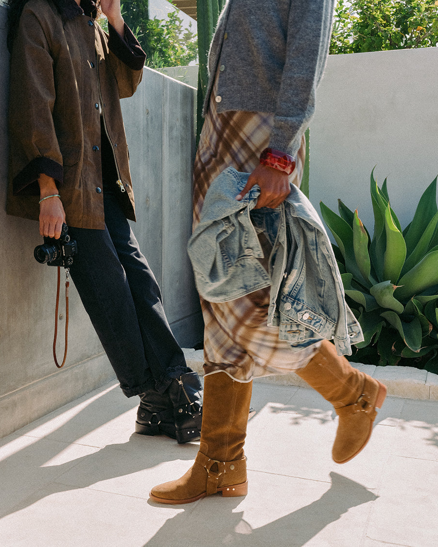 Women wearing Grackle leathr boots in black and Kestrel suede boots in chestnut, walking