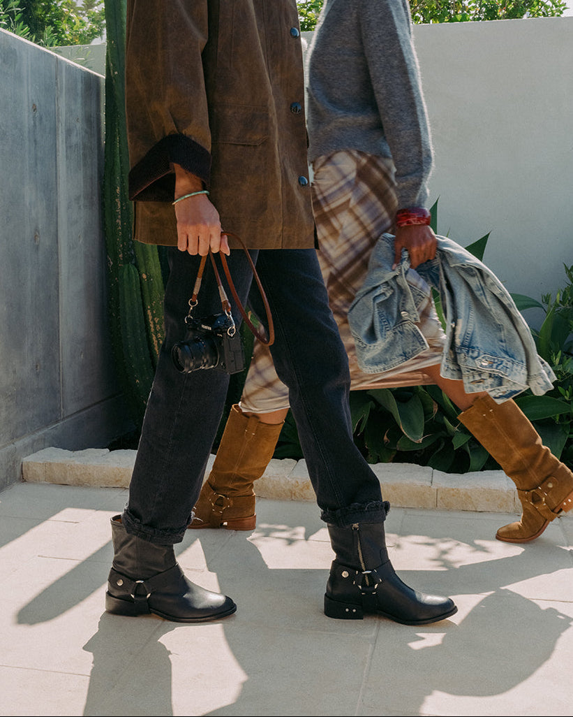 Women wearing Grackle leathr boots in black and Kestrel suede boots in chestnut, walking