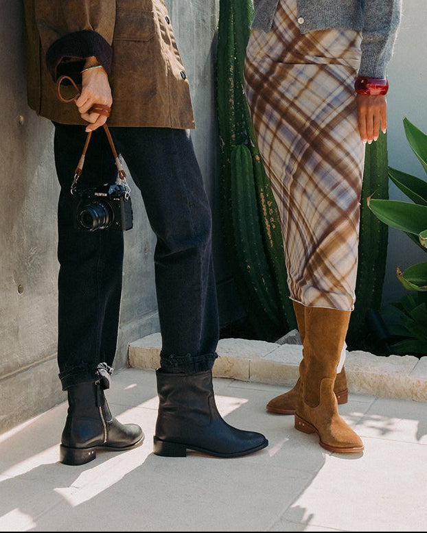 Women wearing Grackle leathr boots in black and Kestrel suede boots in chestnut without the removable harness and buckle