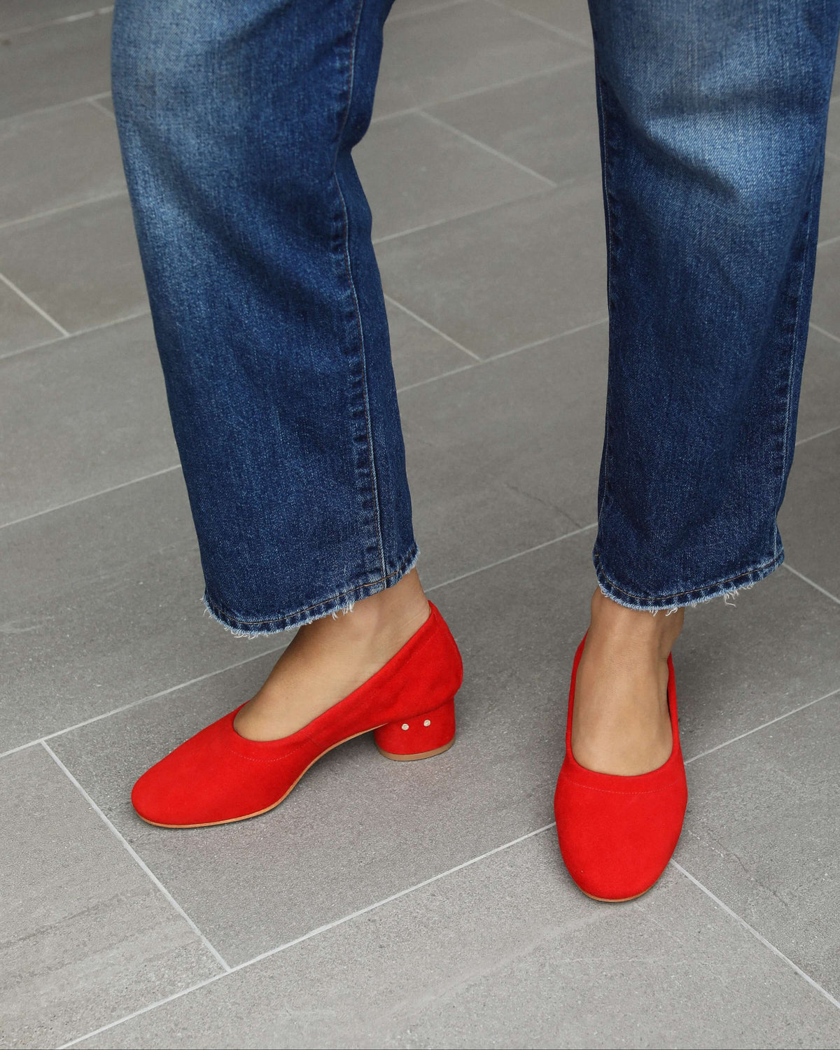 Woman wearing Lina suede ballet heel in poppy with jeans