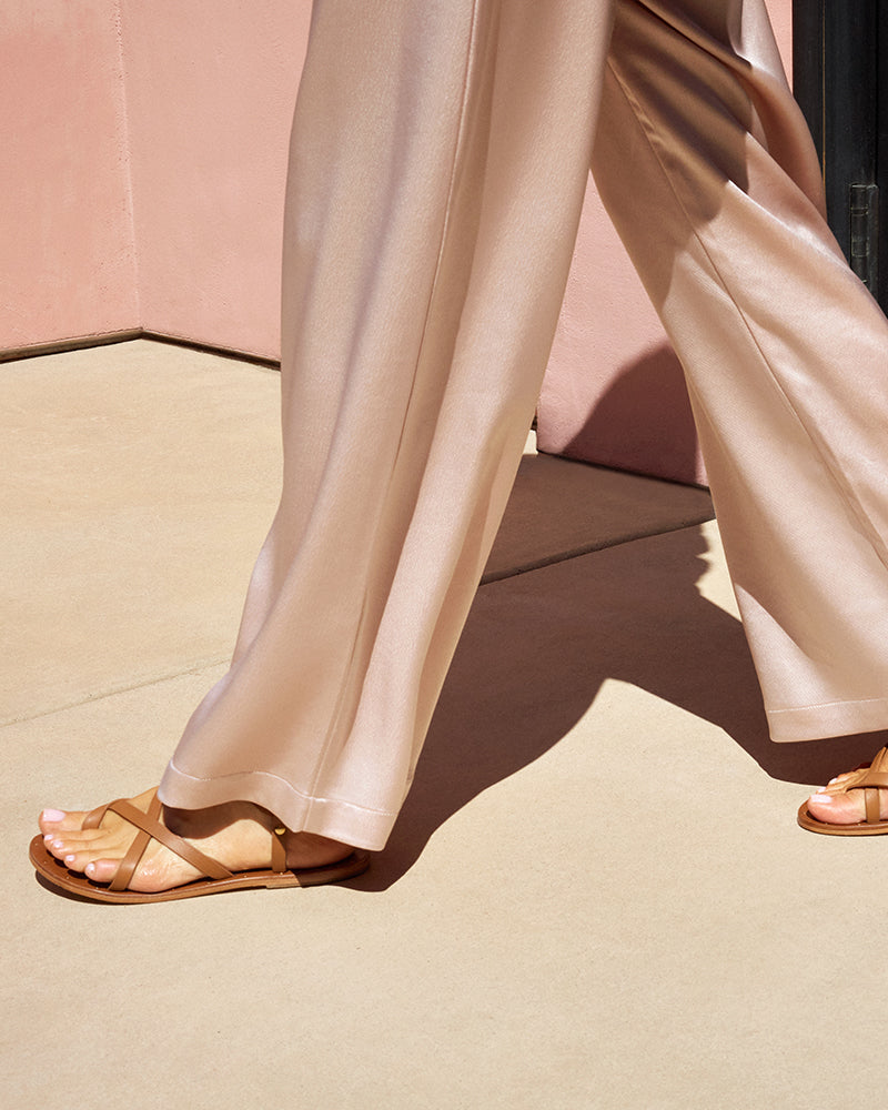 Woman wearing Linnet leather sandals in tan with pink pants