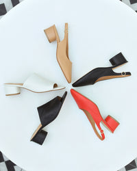 Group shot of Lora leather heeled mules in tomato, black, beach with Stilt in black and vanilla