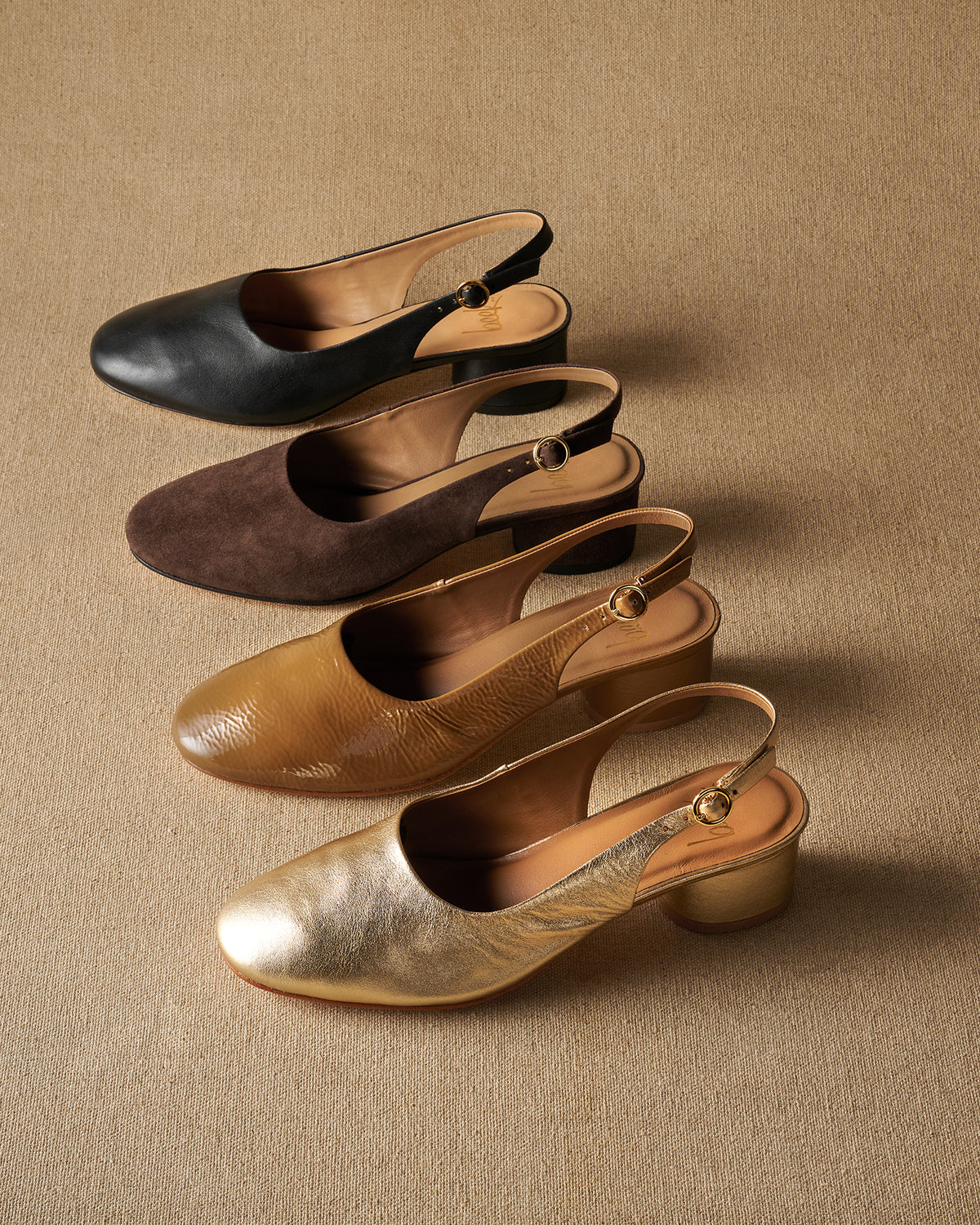 Group shot of Lora heeled ballet in black leather, suede coffee, latte patent leather, gold leather.