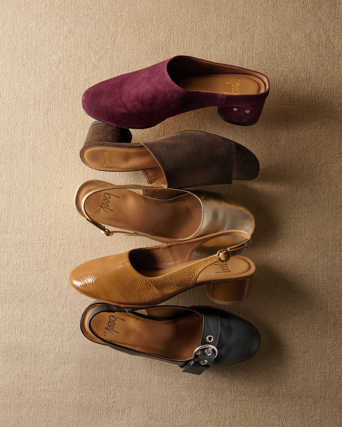 Group shot of Jay suede mule in prune, Stilt Suede heel in coffee, Lora slingback heel in gold leather and patent leather latte, Rhea leather heel in black