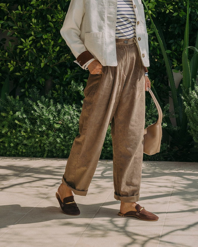 Woman wearing Mallard suede loafer mule in coffee with pants