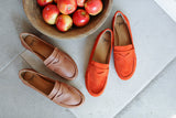Moorhen moccasins in cognac leather and pumpkin suede next to bowl of apples.