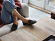 Woman wearing Moorhen suede loafers in ivy with jeans on couch