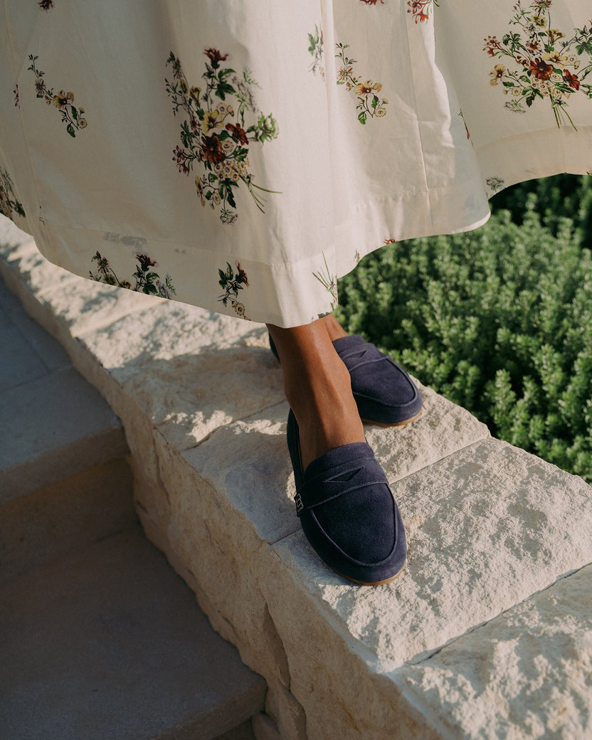 Woman wearing Moorhen suede loafer in navy with floral dress