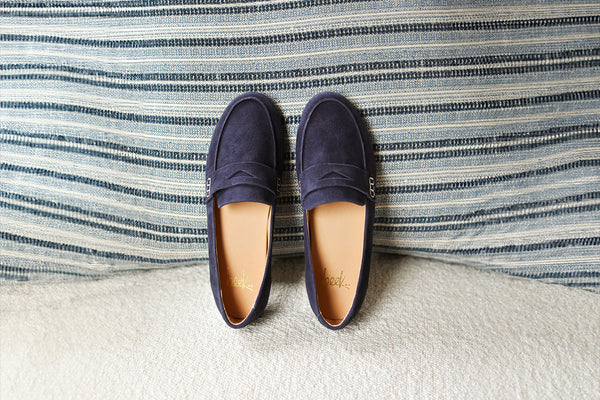 Moorhen suede loafers in navy propped on pillow