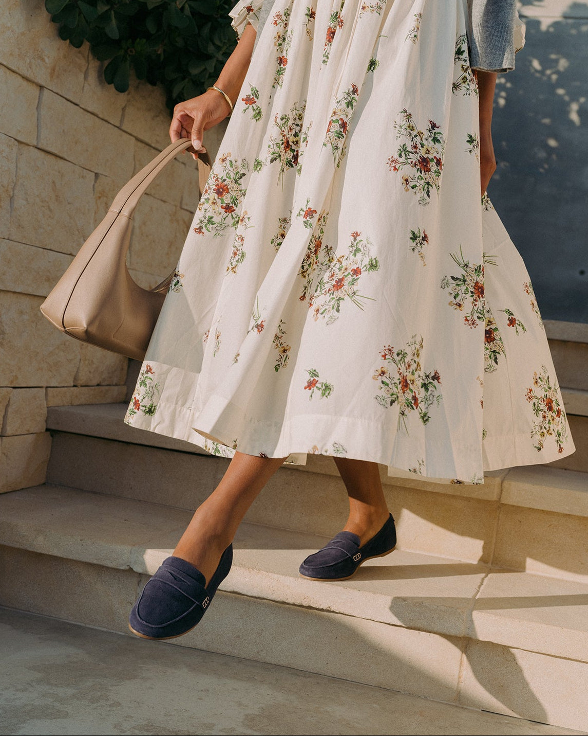 Woman wearing Moorhen suede loafer in navy with floral dress