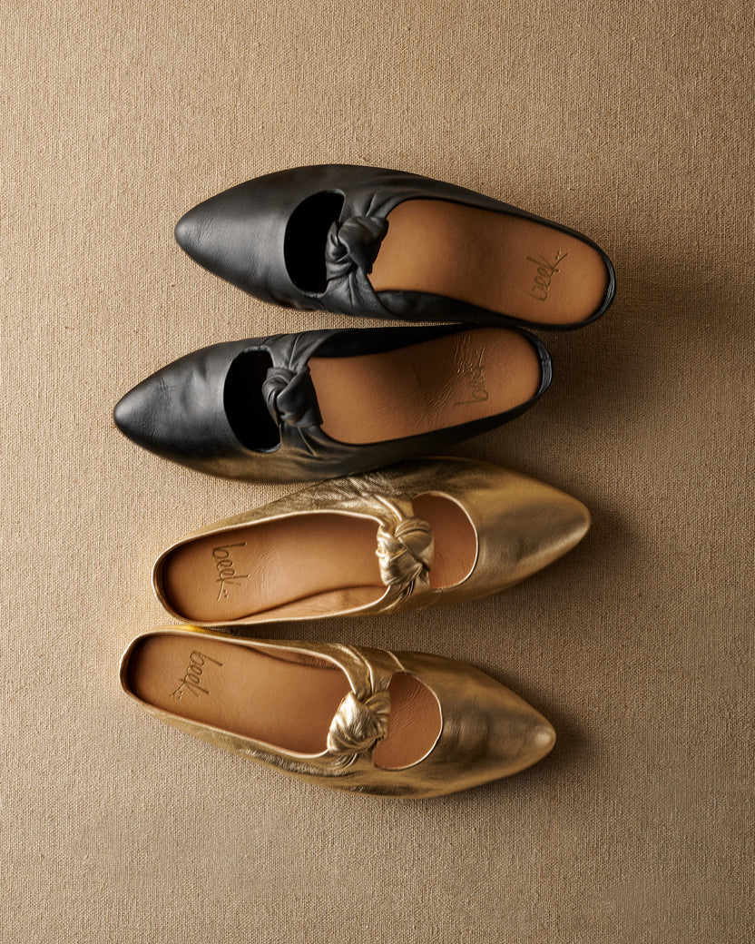 Group shot of Noddy leather backless ballet mule in black and gold.