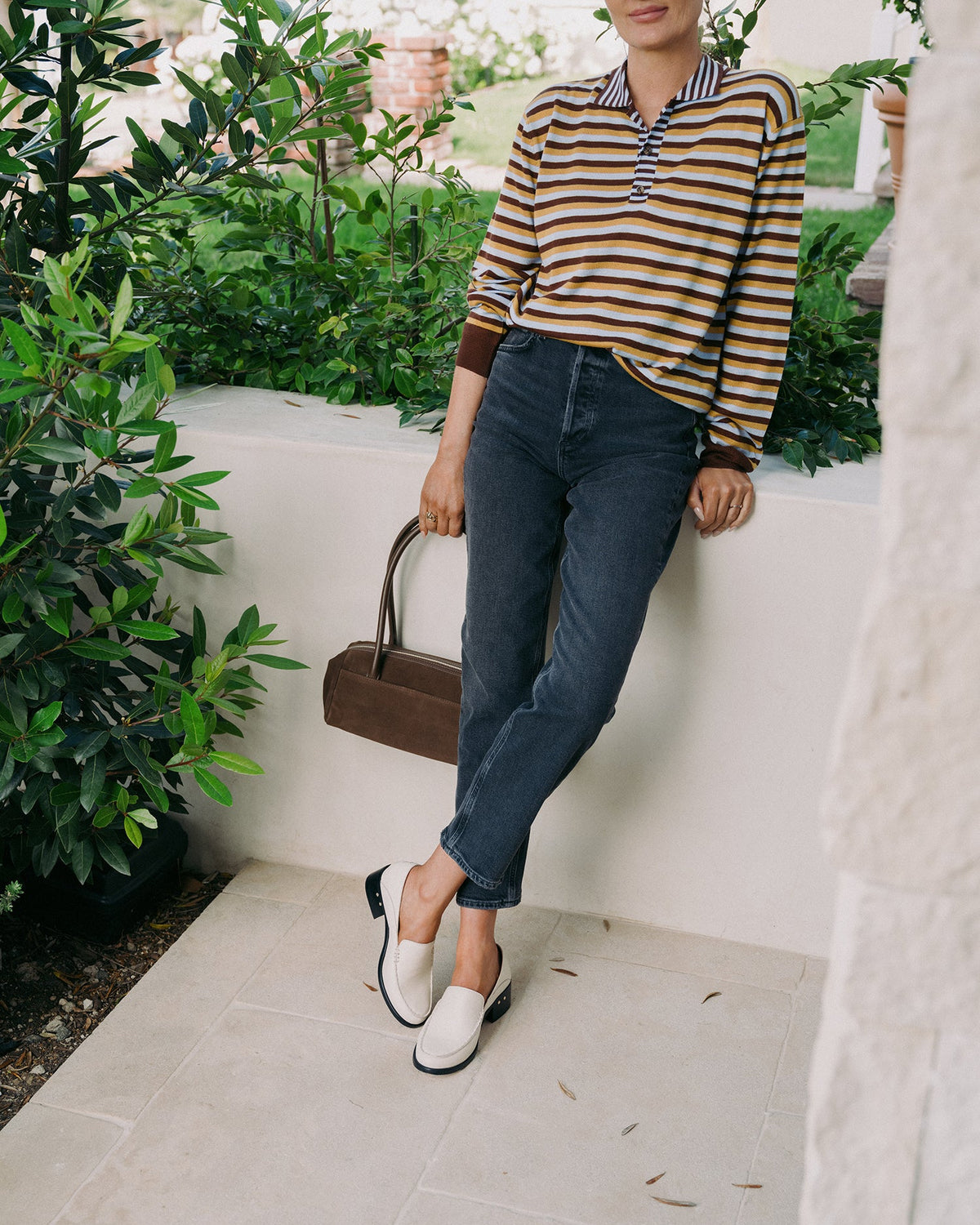 Woman wearing Owl leather heeled loafers in eggshell with jeans and striped top