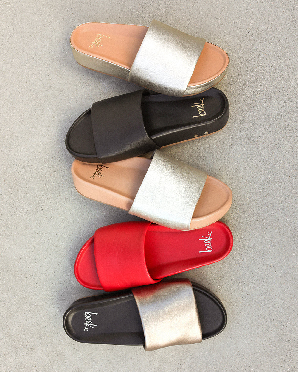 Group shot of Pelican leather platform sandals in bronze/black, lipstick, platinum/beach, black, and platinum.
