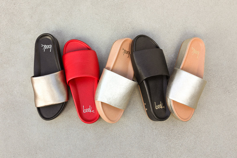 Group shot of Pelican leather platform sandals in bronze/black, lipstick, platinum/beach, black, and platinum.