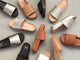 Group shot of Pelican leather platform sandals in bronze/black, tan, platinum/beach, black, platinum, and honey.