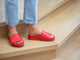 Woman wearing Pelican leather platform slide sandals in lipstick with jeans