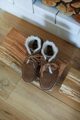 Penguin suede bootie in chestnut on wooden bench