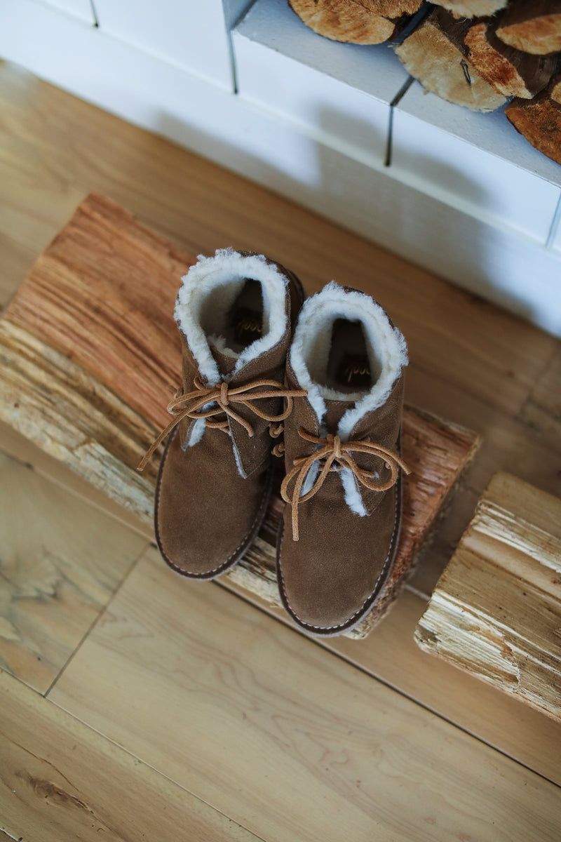 Penguin suede bootie in chestnut on wooden bench